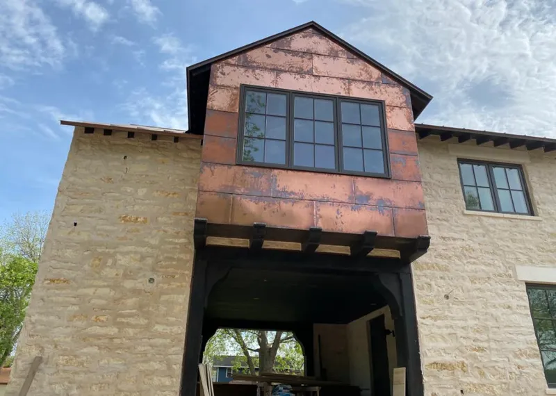 Copper metal panel facade on a stone building for Skylight Installation in Newington